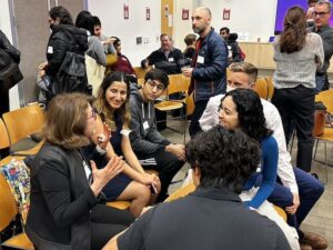 Attendees chatting during a break at C&C