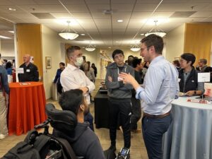 Attendees chat during the career fair at C&C