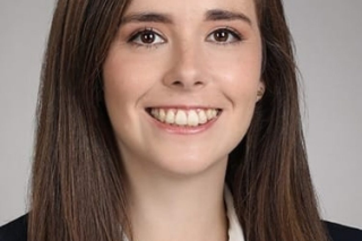 Bruna Gomes headshot. SHe is wearing a black blazer over a white collard shirt.