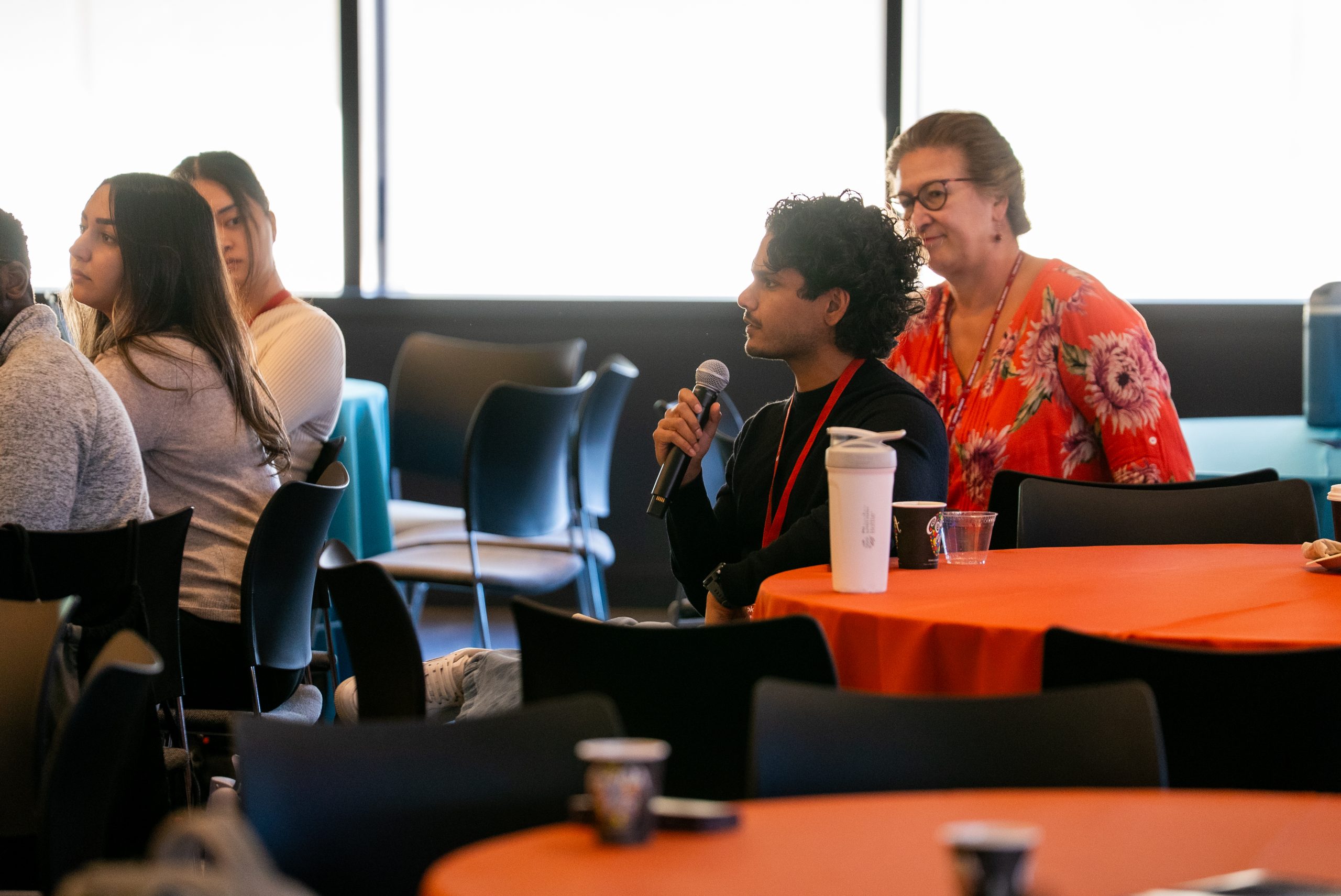 Shlok Natarajan asks Ida Sim a question from the audience during the fireside chat at the 2026 DBDS Retreat