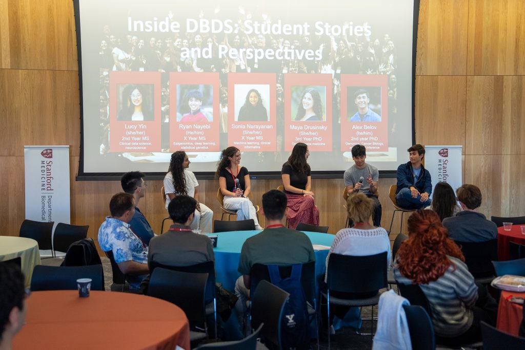 Five students lead a student panel discussion in front of a student audience at the 2026 DBDS Retreat. From left to right: Sonia Narayanan, Maya Drusinksy, Lucy Yin, Ryan Nayebi, and Alex Belov