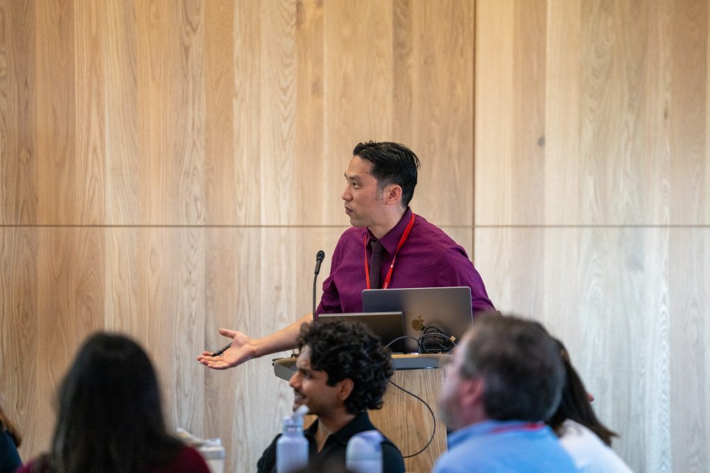 Professor Jonathan Chen moderating the State of the Field panel at the 2026 DBDS Retreat. He is standing that the podium.