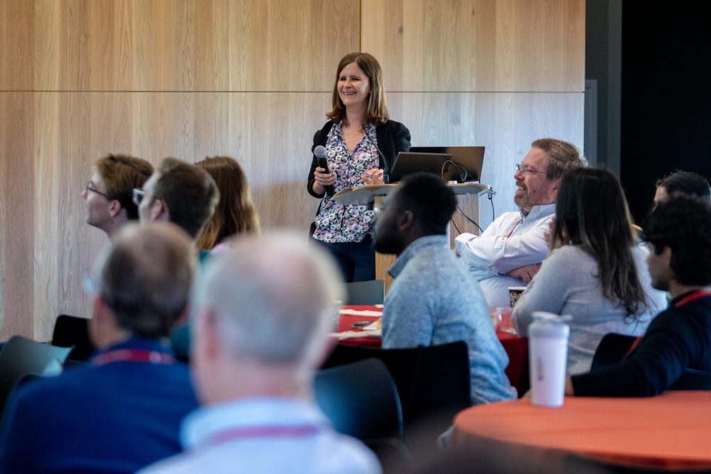 Professor Emily Alsentzer standing at the podium at the 2026 DBDS Retreat.